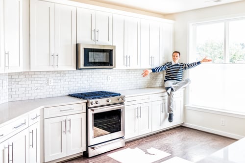 Young man sitting in a well-lit kitchen