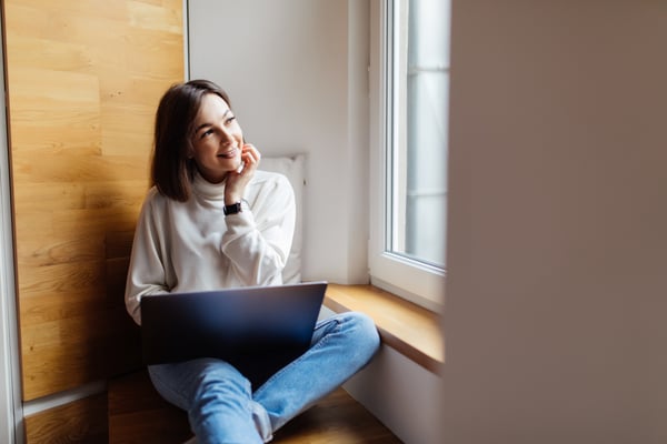 woman looking through a casement window